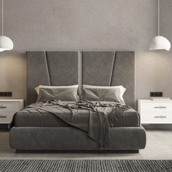 Dormitorio de estilo industrial con cabecero alto gris de líneas geométricas y mesitas blancas frente a pared de cemento.